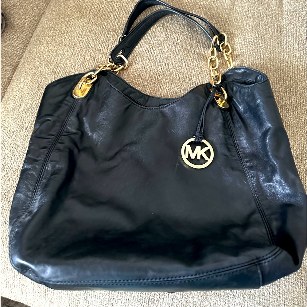 Leather Michael Kor. Gold chain, and decal.